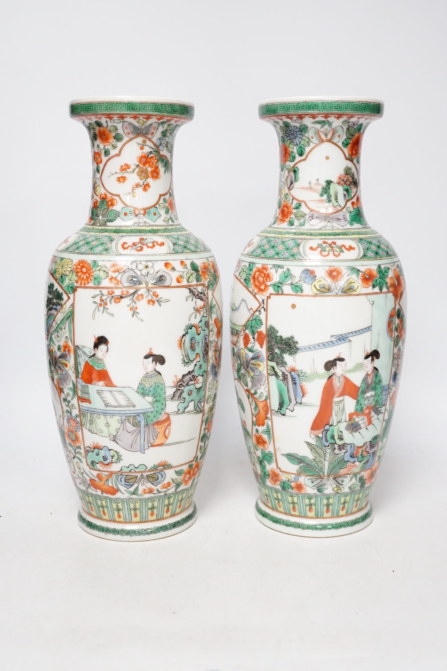 A pair of 20th century Chinese famille verte vases and a figure, tallest 31cm